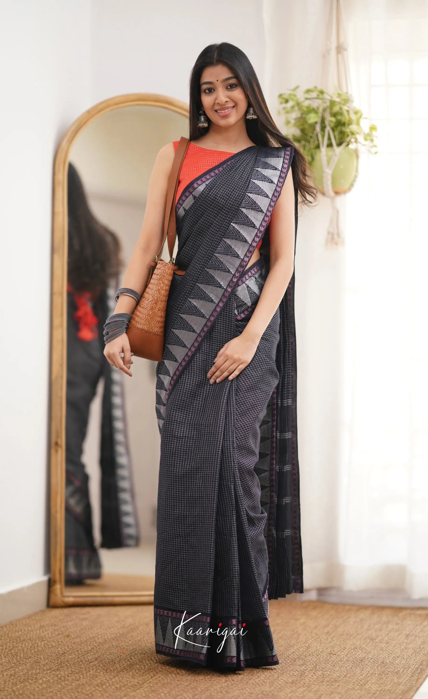 Saaral Black Shade And Orange Tone Sungudi Saree Sarees