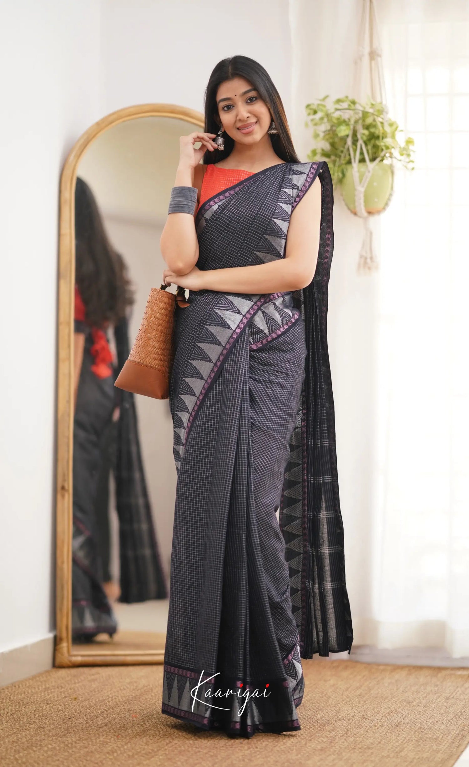 Saaral Black Shade And Orange Tone Sungudi Saree Sarees